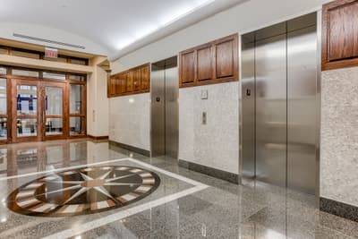 Millennium Plaza elevator lobby with granite floors and oak trim