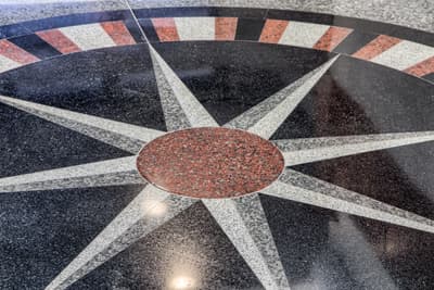 Custom granite compass rose inlay in Millennium Plaza lobby floor