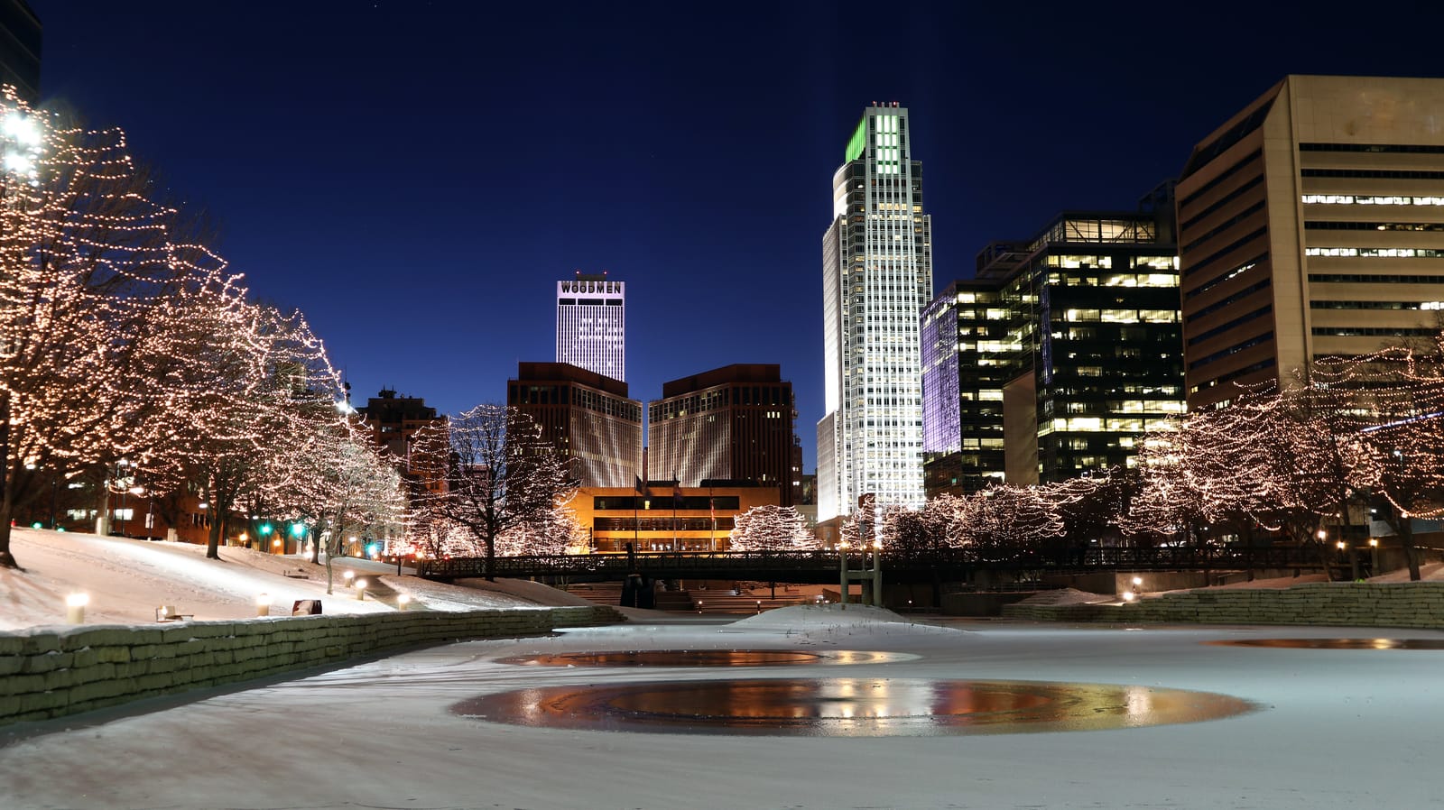 Downtown Omaha at night with holiday lights and office buildings